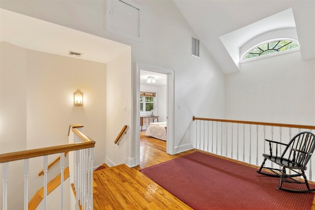 7 Ravine Dr, Hastings-On-Hudson, NY 10706 - hall featuring an upstairs landing, plenty of natural light, light wood-style flooring, and high vaulted ceiling