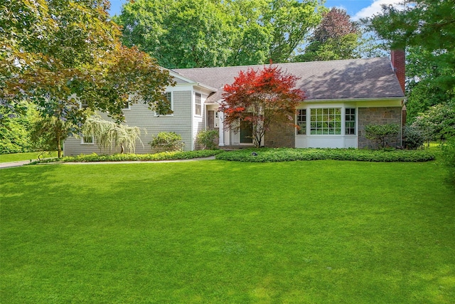 68 Greenhaven Rd, Rye, NY 10580 - view of front facade with a chimney, a front lawn, stone siding, and roof with shingles