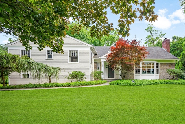 68 Greenhaven Rd, Rye, NY 10580 - view of front facade featuring a front lawn, a chimney, roof with shingles, and stone siding
