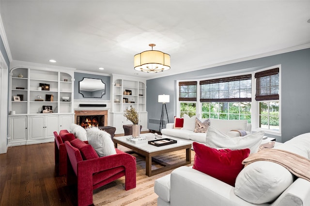 68 Greenhaven Rd, Rye, NY 10580 - living area with ornamental molding, a chandelier, dark wood-style flooring, recessed lighting, and a lit fireplace