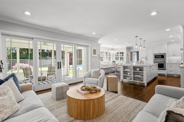 68 Greenhaven Rd, Rye, NY 10580 - living room with crown molding, dark wood-style flooring, recessed lighting, french doors, and a chandelier