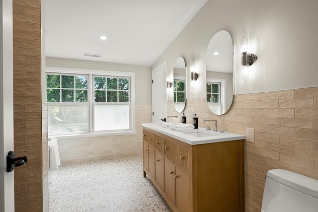 68 Greenhaven Rd, Rye, NY 10580 - bathroom with tile walls, double vanity, and a wainscoted wall