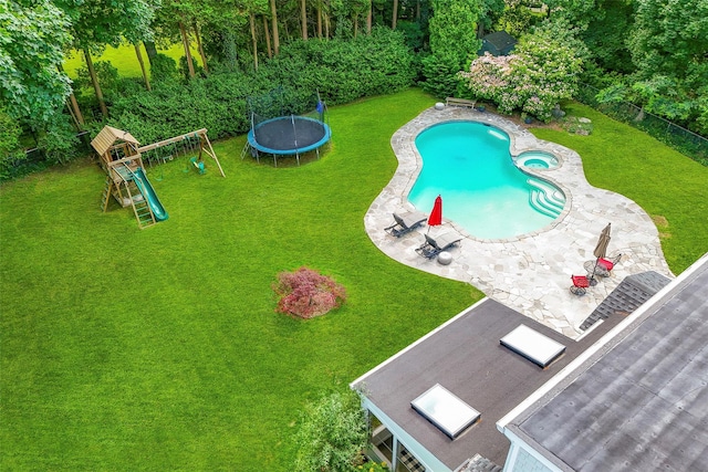 68 Greenhaven Rd, Rye, NY 10580 - view of swimming pool featuring a patio, a trampoline, a lawn, a playground, and a pool with connected hot tub