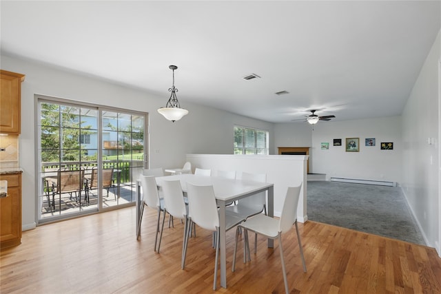 15 Prestwick Dr, Monroe, NY 10950 - dining room featuring a baseboard heating unit, ceiling fan, light wood-style flooring, and plenty of natural light
