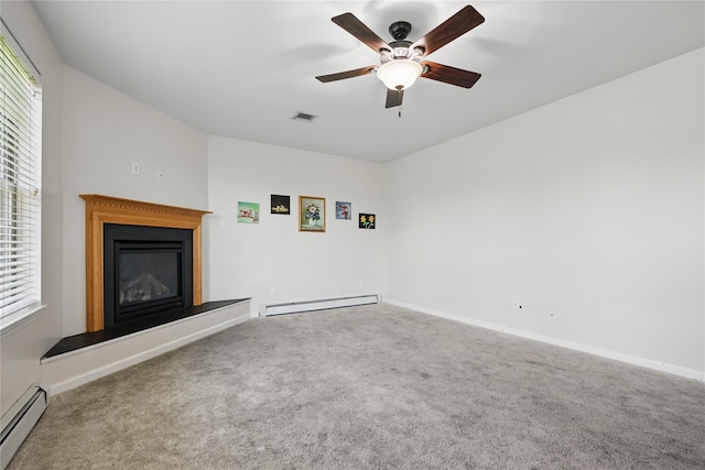 15 Prestwick Dr, Monroe, NY 10950 - unfurnished living room featuring a baseboard radiator, baseboard heating, carpet, a glass covered fireplace, and plenty of natural light