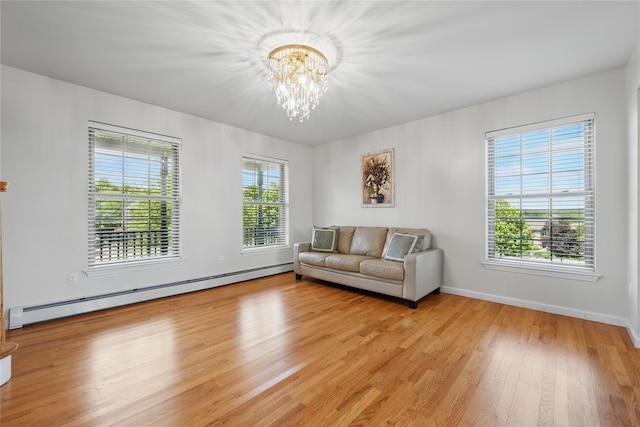 15 Prestwick Dr, Monroe, NY 10950 - living room with a baseboard heating unit, a chandelier, light wood-type flooring, and baseboards