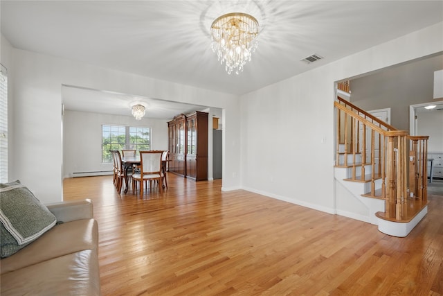 15 Prestwick Dr, Monroe, NY 10950 - living area with a chandelier, light wood finished floors, a baseboard radiator, and stairs