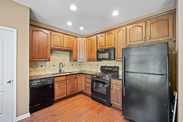 837 Huntington Dr Unit 152, Fishkill, NY 12524 - kitchen with black appliances, a sink, dark countertops, light wood-style flooring, and recessed lighting