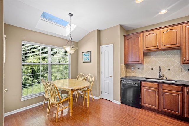 837 Huntington Dr Unit 152, Fishkill, NY 12524 - kitchen with dishwasher, a sink, a skylight, baseboards, and vaulted ceiling