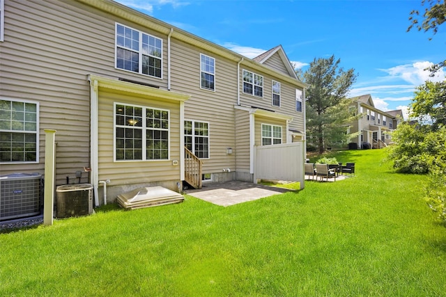 837 Huntington Dr Unit 152, Fishkill, NY 12524 - back of house with cooling unit, a yard, and a patio area