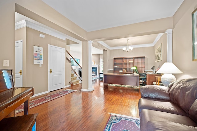 837 Huntington Dr Unit 152, Fishkill, NY 12524 - living area featuring decorative columns, wood-type flooring, stairs, a glass covered fireplace, and baseboards