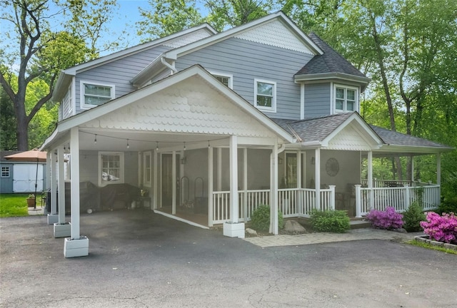 416 Sleepy Hollow Rd, Briarcliff Manor, NY 10510 - view of front of home with a carport, covered porch, a shingled roof, and driveway