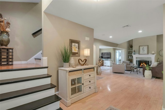 416 Sleepy Hollow Rd, Briarcliff Manor, NY 10510 - stairs with wood finished floors, a warm lit fireplace, and recessed lighting