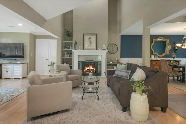 416 Sleepy Hollow Rd, Briarcliff Manor, NY 10510 - living room featuring wood finished floors, a chandelier, a high ceiling, a tiled fireplace, and recessed lighting