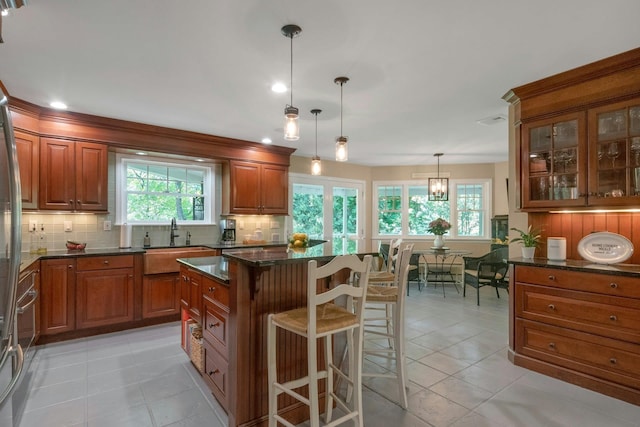 416 Sleepy Hollow Rd, Briarcliff Manor, NY 10510 - kitchen featuring a sink, brown cabinets, tasteful backsplash, and recessed lighting