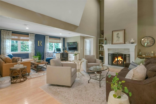 416 Sleepy Hollow Rd, Briarcliff Manor, NY 10510 - living area with a tile fireplace, light wood-style flooring, a towering ceiling, and recessed lighting