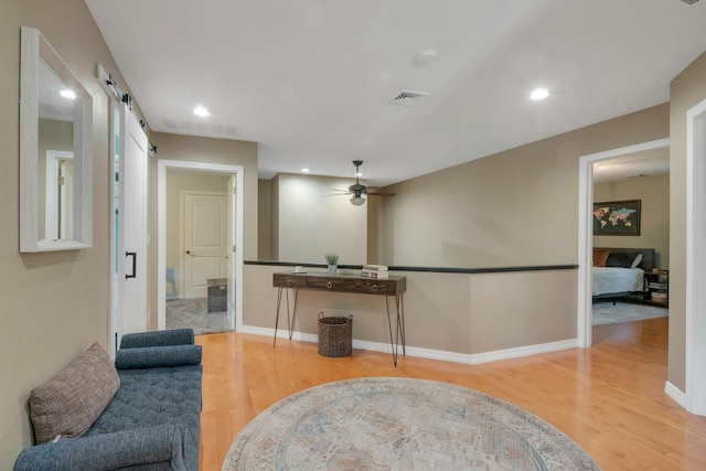 416 Sleepy Hollow Rd, Briarcliff Manor, NY 10510 - living room featuring a barn door, wood finished floors, a ceiling fan, recessed lighting, and baseboards