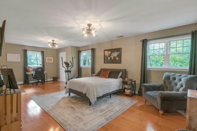 416 Sleepy Hollow Rd, Briarcliff Manor, NY 10510 - bedroom featuring a chandelier and light wood-style flooring