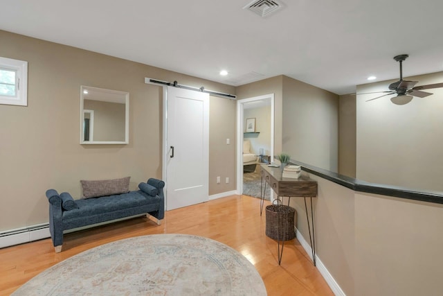 416 Sleepy Hollow Rd, Briarcliff Manor, NY 10510 - sitting room with a barn door, light wood-style floors, recessed lighting, ceiling fan, and baseboards