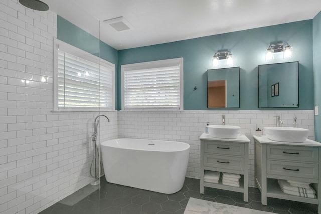 416 Sleepy Hollow Rd, Briarcliff Manor, NY 10510 - bathroom with tile walls, a soaking tub, two vanities, tile patterned floors, and a wainscoted wall