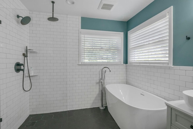 416 Sleepy Hollow Rd, Briarcliff Manor, NY 10510 - full bath with a tile shower, a freestanding tub, vanity, tile walls, and tile patterned flooring