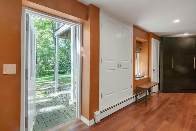 416 Sleepy Hollow Rd, Briarcliff Manor, NY 10510 - doorway featuring light wood-style flooring, a baseboard heating unit, baseboards, and recessed lighting