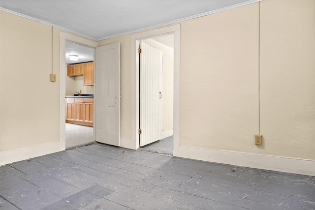 1 Green St, Gilbertsville, NY 13776 - unfurnished bedroom featuring baseboards, crown molding, a sink, and a closet
