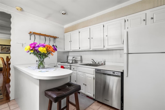 98 Bluespruce Rd, Levittown, NY 11756 - kitchen with white appliances, a sink, light tile patterned floors, and light countertops