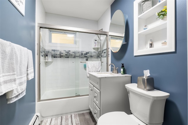 98 Bluespruce Rd, Levittown, NY 11756 - full bath featuring vanity, toilet, bath / shower combo with glass door, and wood finished floors