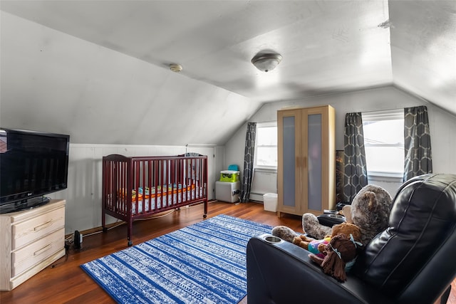 98 Bluespruce Rd, Levittown, NY 11756 - bedroom with lofted ceiling, wood finished floors, and a baseboard radiator