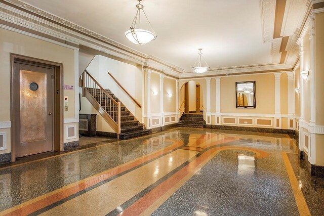 35-53 77th St Unit 5H, Jackson Heights, NY 11372 - community lobby featuring a decorative wall, a wainscoted wall, ornamental molding, and stairway