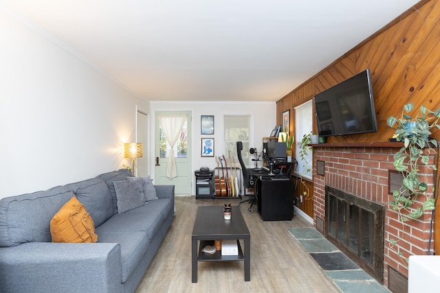 137C Shore Rd, Mount Sinai, NY 11766 - living area featuring a brick fireplace, crown molding, light wood-style floors, and wooden walls