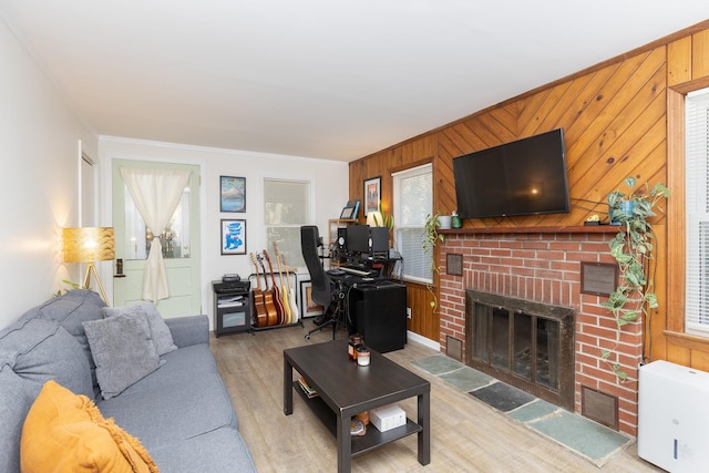 137C Shore Rd, Mount Sinai, NY 11766 - living room with wood finished floors, a fireplace, ornamental molding, and wood walls