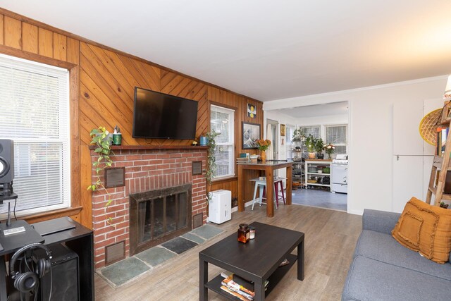 137C Shore Rd, Mount Sinai, NY 11766 - living room with healthy amount of natural light, wood finished floors, a fireplace, wood walls, and ornamental molding