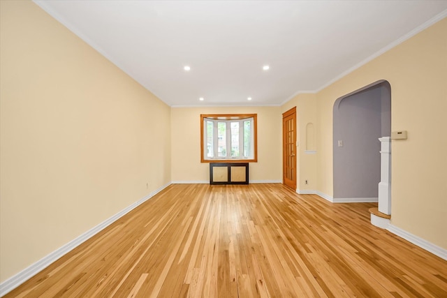 21-22 150th St, Whitestone, NY 11357 - unfurnished room with light wood-style flooring, arched walkways, baseboards, ornamental molding, and recessed lighting