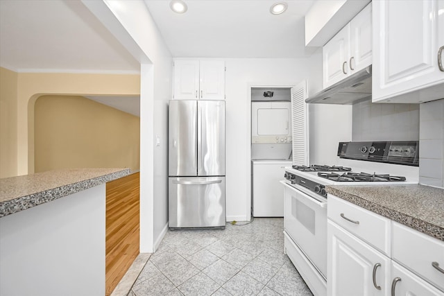 21-22 150th St, Whitestone, NY 11357 - kitchen featuring freestanding refrigerator, white range with gas cooktop, estacked washer and dryer, under cabinet range hood, and recessed lighting