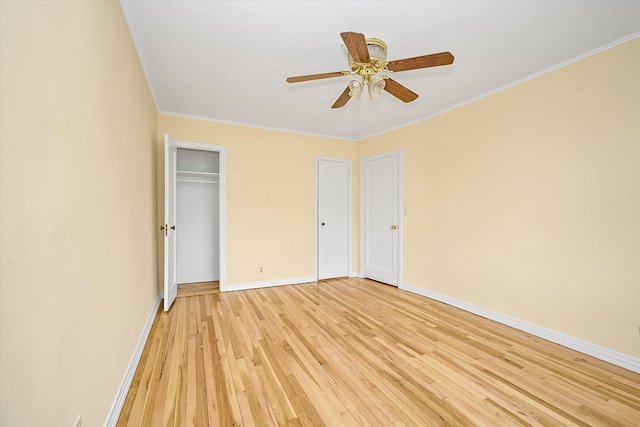 21-22 150th St, Whitestone, NY 11357 - unfurnished bedroom with light wood-style flooring, baseboards, crown molding, multiple closets, and ceiling fan