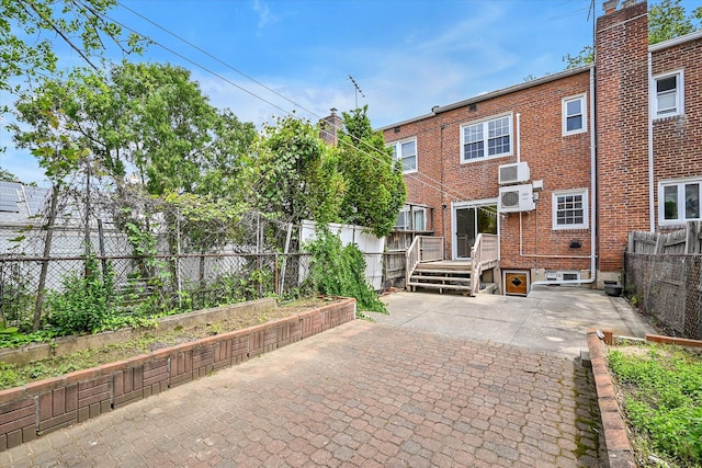 21-22 150th St, Whitestone, NY 11357 - rear view of house featuring a patio, brick siding, and a fenced backyard