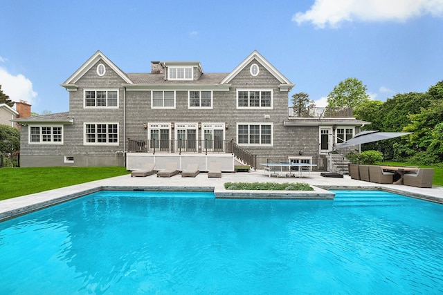1015 Seven Oaks Ln, Mamaroneck, NY 10543 - swimming pool with stairs, a patio area, and an outdoor hangout area