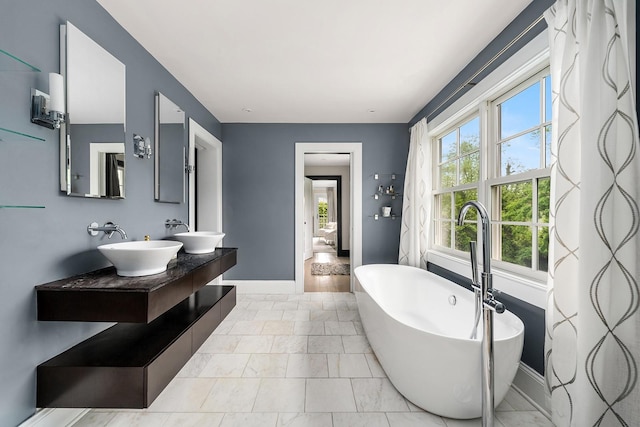 1015 Seven Oaks Ln, Mamaroneck, NY 10543 - full bathroom featuring a sink, baseboards, and a freestanding bath