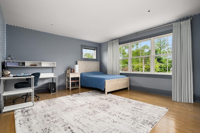 1015 Seven Oaks Ln, Mamaroneck, NY 10543 - bedroom with wood finished floors, baseboards, and a desk