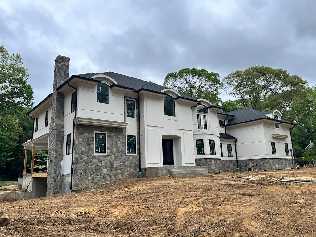 17 Chelsea Pl, Dix Hills, NY 11746 - view of front of property with stone siding, a chimney, and stucco siding