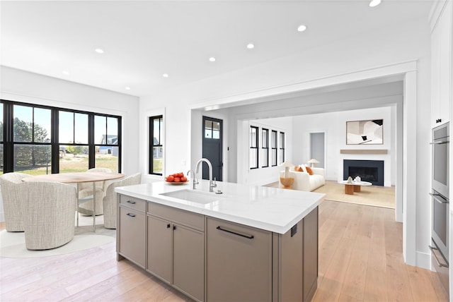 35 Club Dr, Baiting Hollow, NY 11933 - kitchen featuring a sink, gray cabinetry, open floor plan, an island with sink, and recessed lighting
