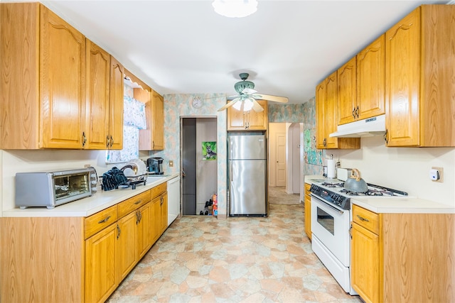 kitchen with white appliances, under cabinet range hood, light countertops, and ceiling fan