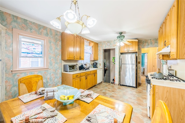 kitchen with white appliances, under cabinet range hood, light countertops, plenty of natural light, and wallpapered walls