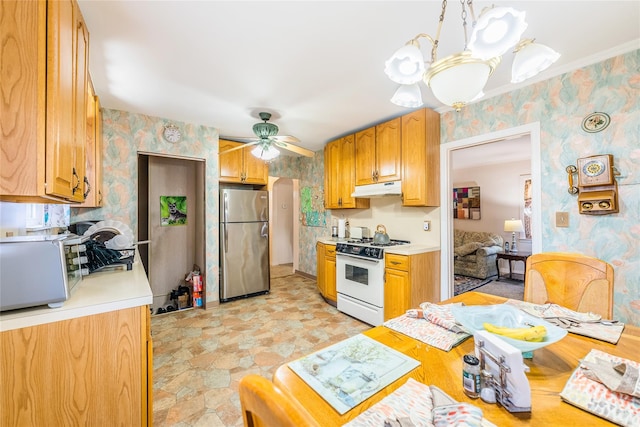 kitchen featuring appliances with stainless steel finishes, under cabinet range hood, wallpapered walls, light countertops, and ceiling fan