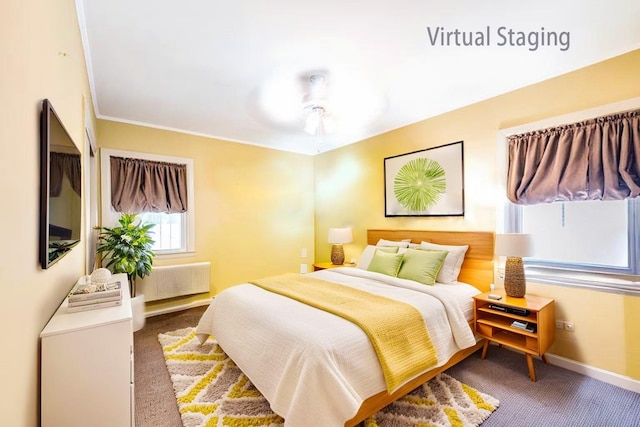 carpeted bedroom with radiator, baseboards, and a ceiling fan