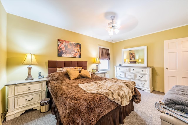 bedroom with light colored carpet, crown molding, a ceiling fan, and baseboards