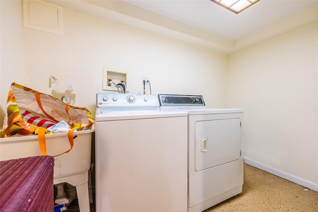 laundry room featuring washer and dryer and baseboards