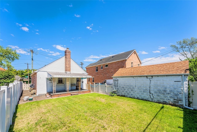back of property with a chimney and brick siding